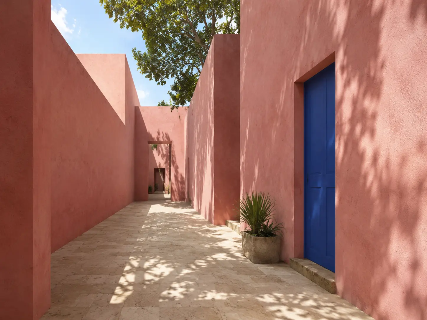Sunlit pink architectural passage with a cobalt doorway and a clear vanishing point